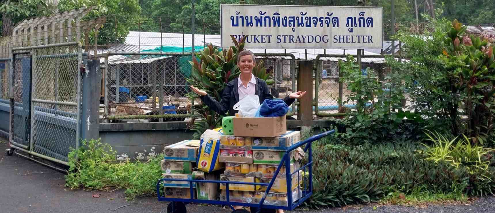 Overflowing food donation cart outside Phuket Straydog Shelter, supporting animal welfare efforts.