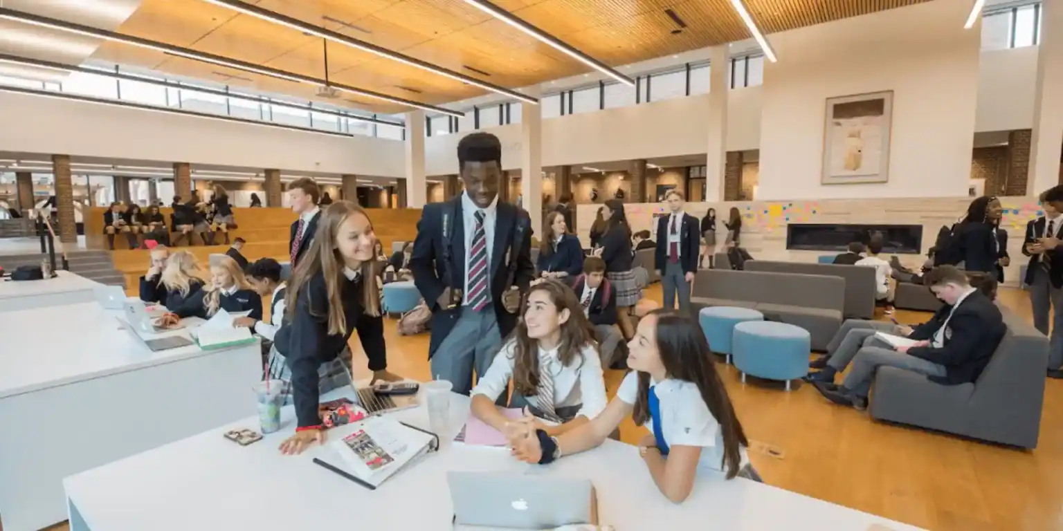Vibrant international school lobby with diverse students engaged in learning activities.