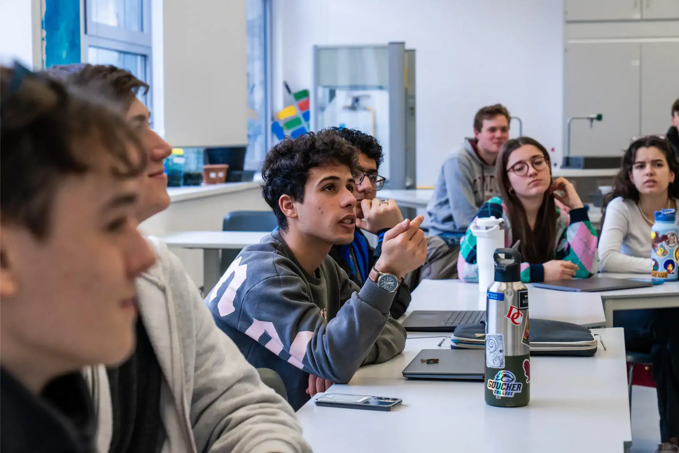 Students engaged in a classroom discussion at a world school promoting international education and academic excellence.