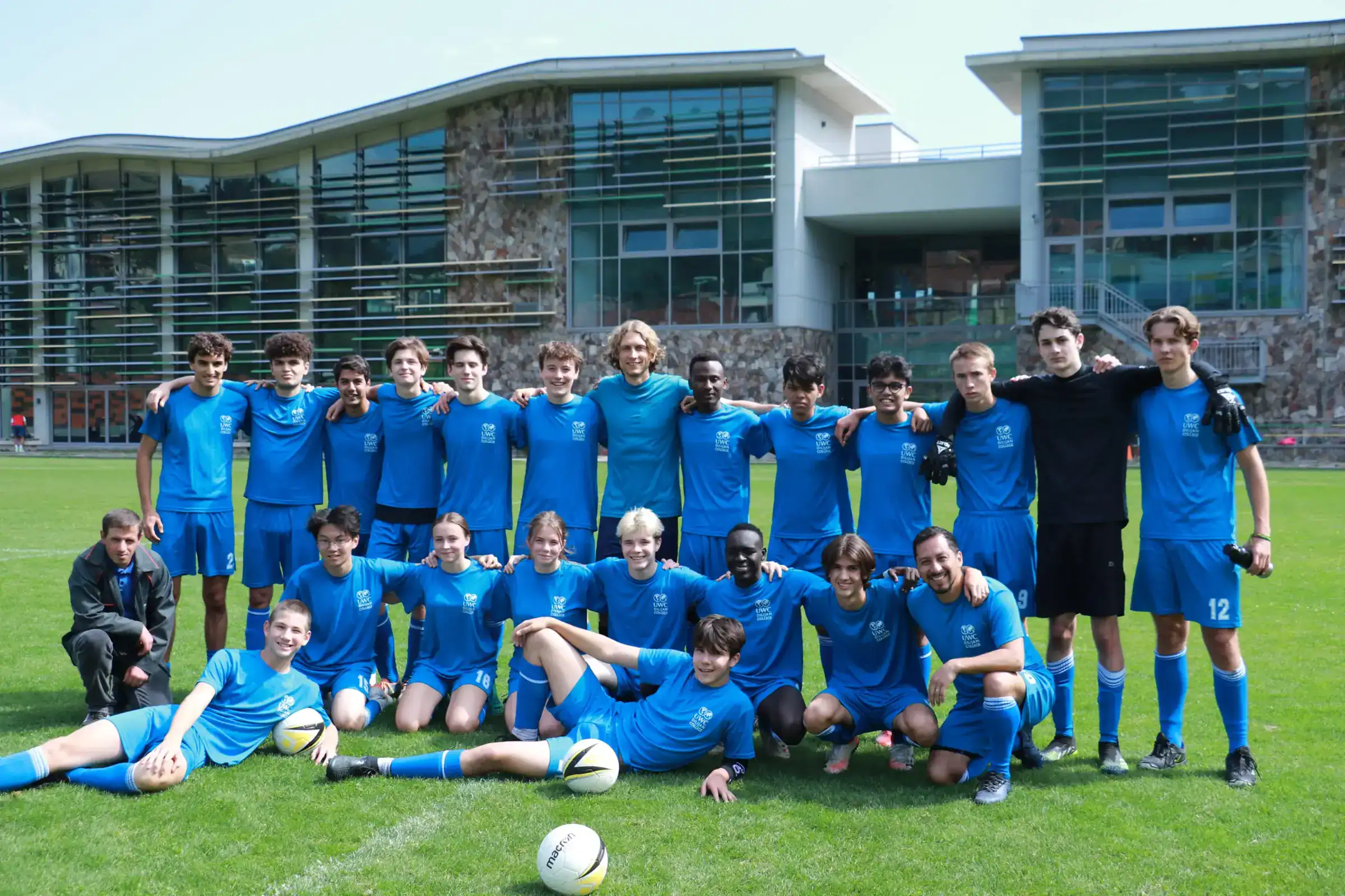 Young diverse soccer team at World Schools sports event, showcasing international student athletics.