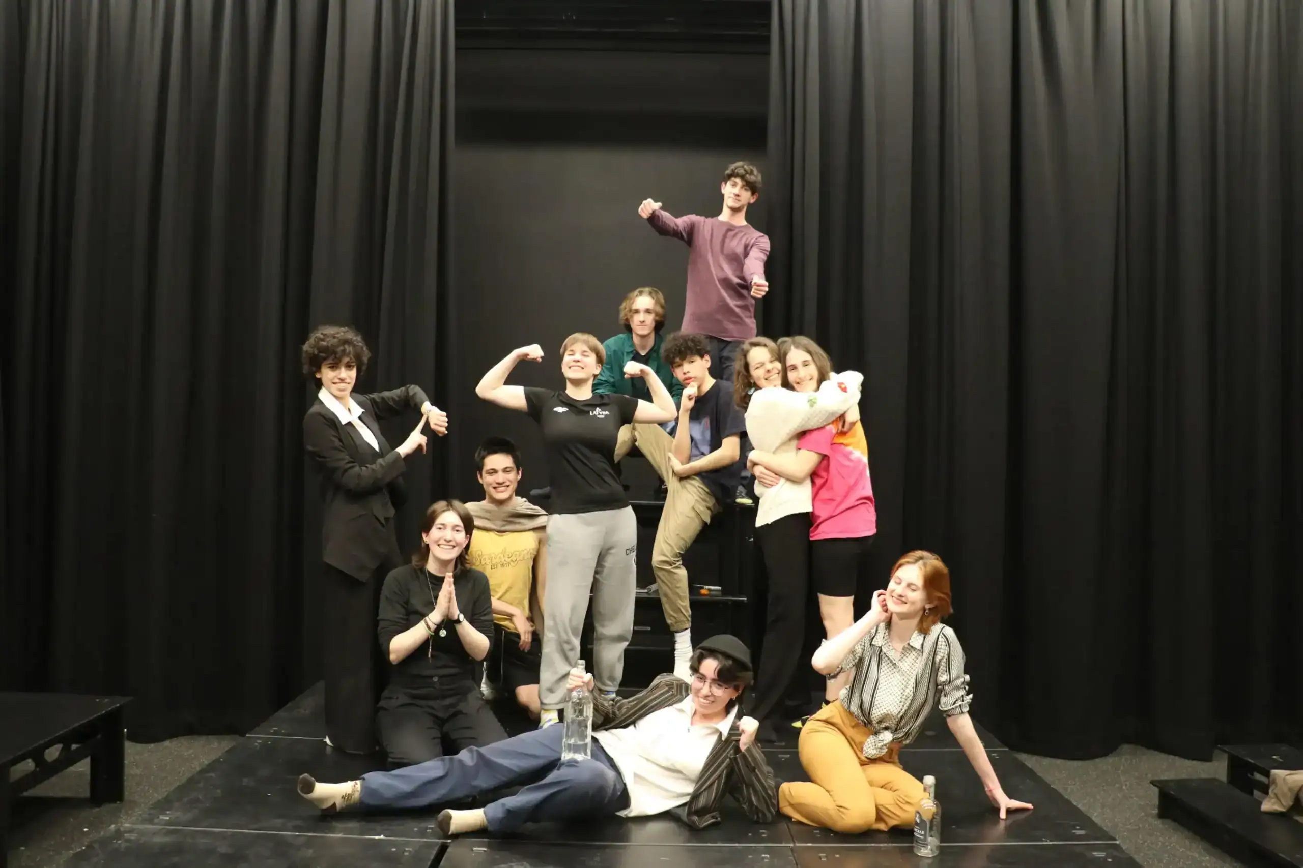 Diverse students on stage celebrating school achievements at World Schools event.