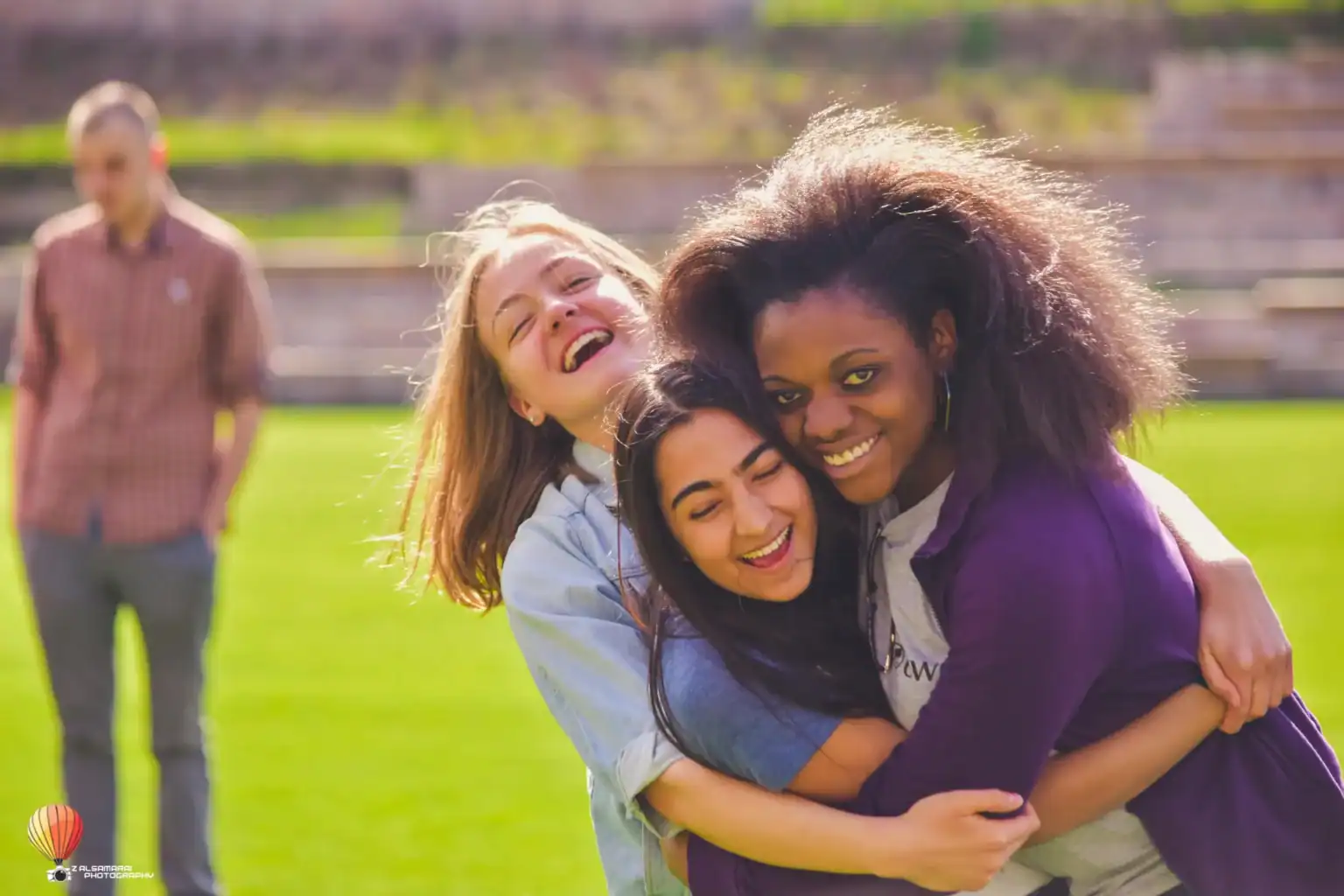Joyful diverse students embracing outdoors at World Schools, fostering global education and multicultural learning.