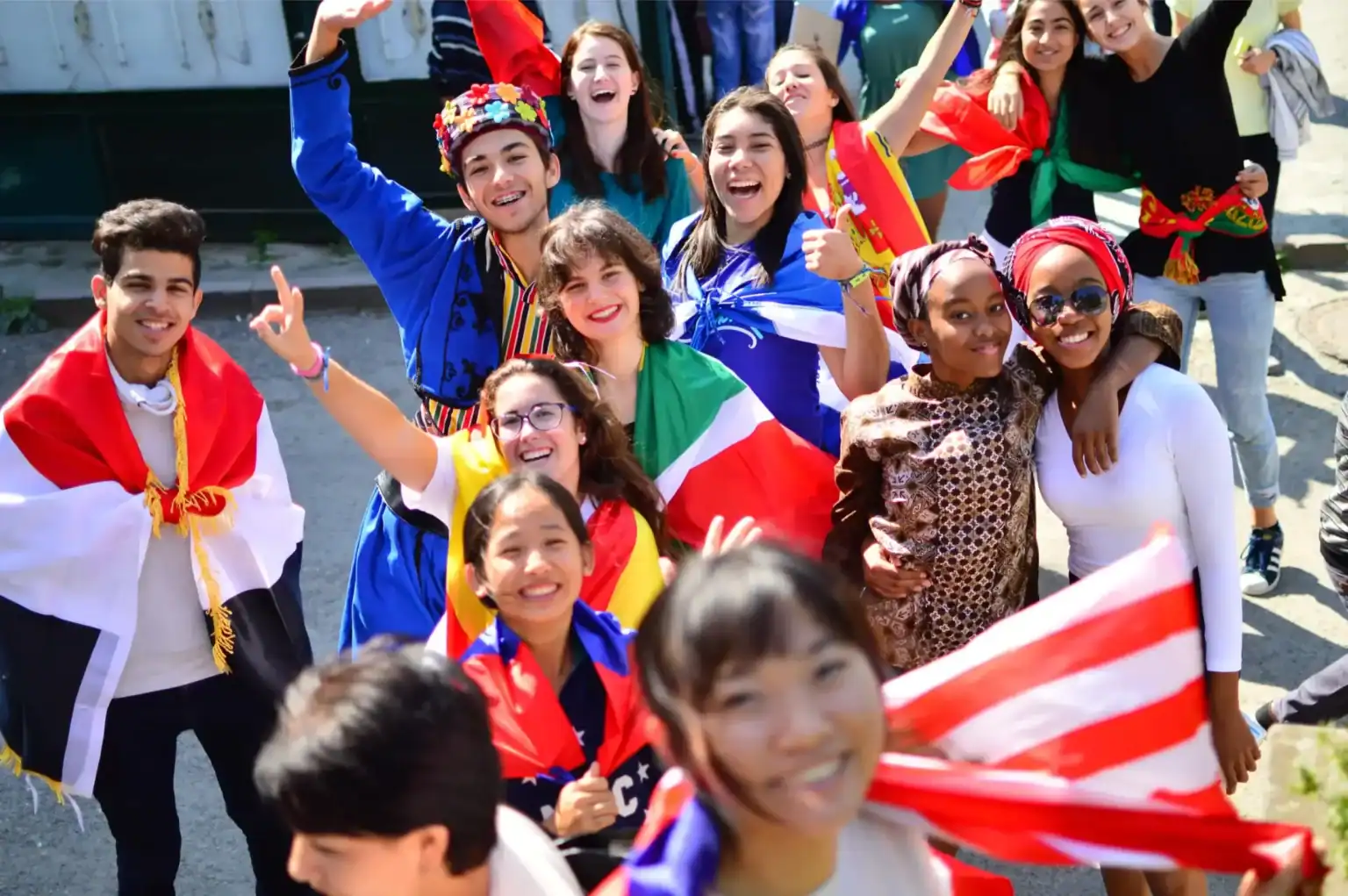 Vibrant international students celebrating with flags from various countries, demonstrating global unity and cultural diversity.