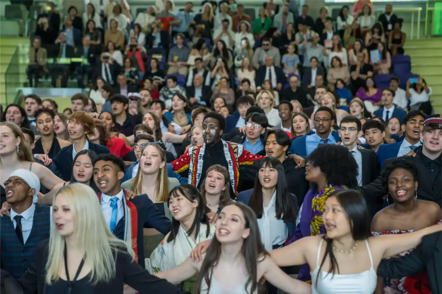 Diverse students at a global school event, celebrating unity and international education.