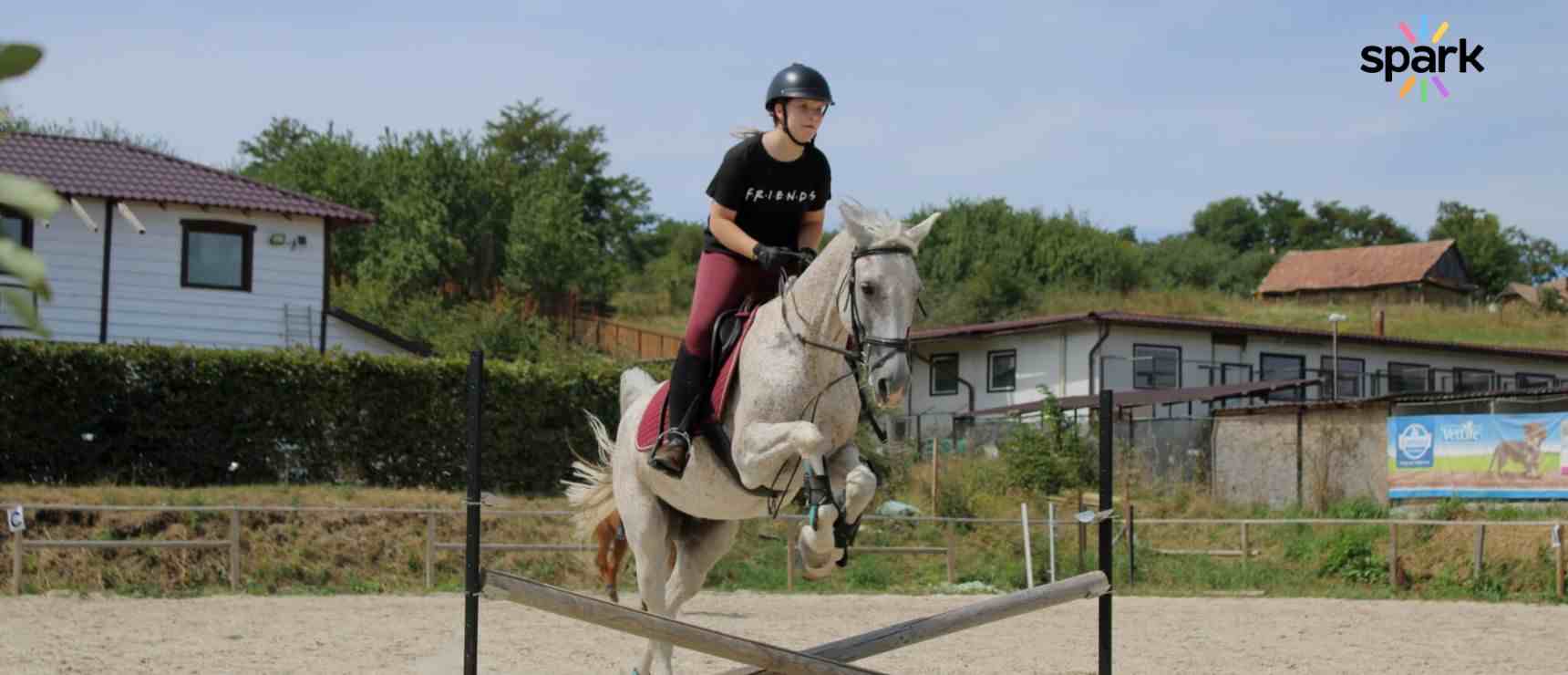 Balancing Academics and Athletics: How Online Education Helps You Excel at Both 2 Young female equestrian riding a horse over a jump at a riding school or equestrian center.