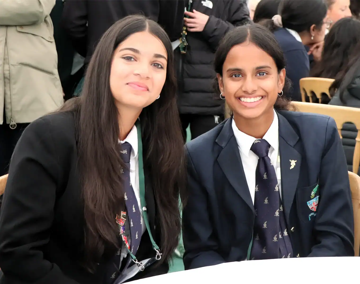 Two smiling female students in school uniforms at RGS Surrey Hills.