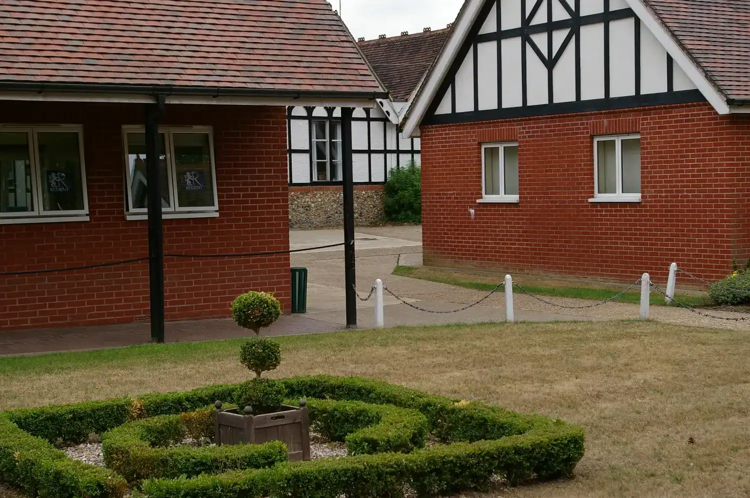Traditional English-style school buildings with well-maintained garden.