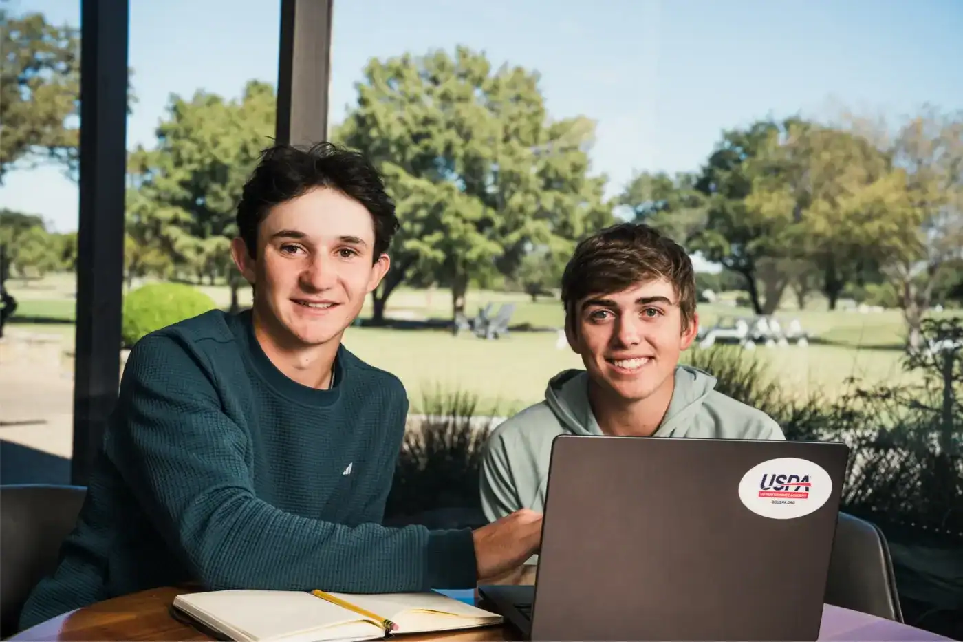 Online private school students studying together with laptop and notebooks.