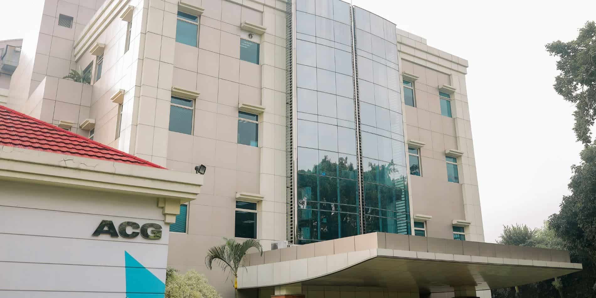 Modern international school building with glass facade and expansive windows.