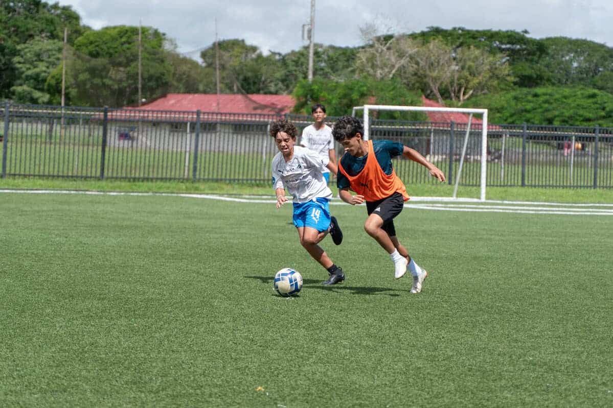 Youth soccer game at World Schools sports complex, highlighting active student participation and athletic excellence.