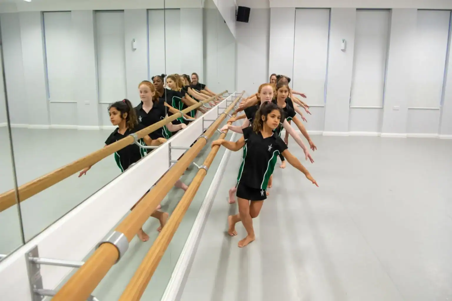 Elegant ballet students practicing at a world-class dance academy for international students.
