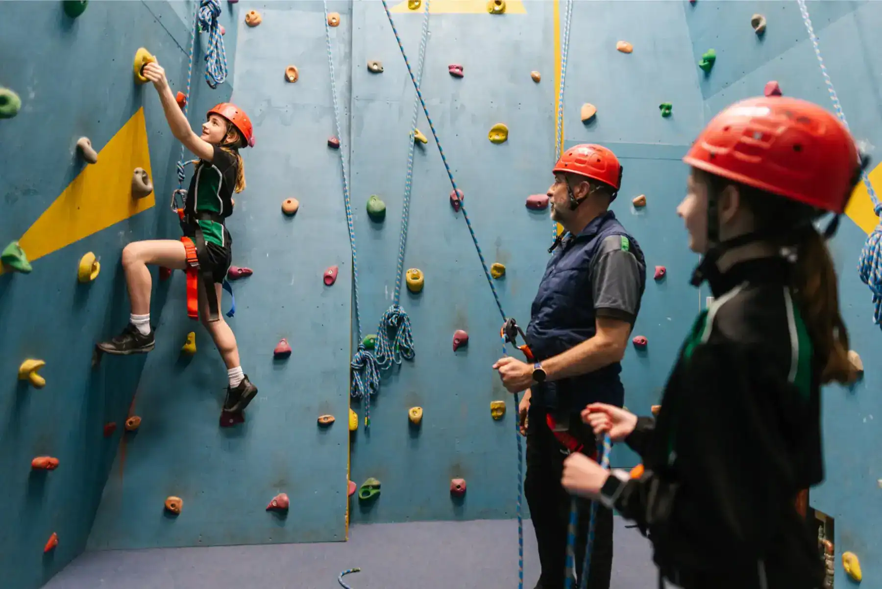 Climbing wall activity at World Schools, promoting adventure and teamwork for students.