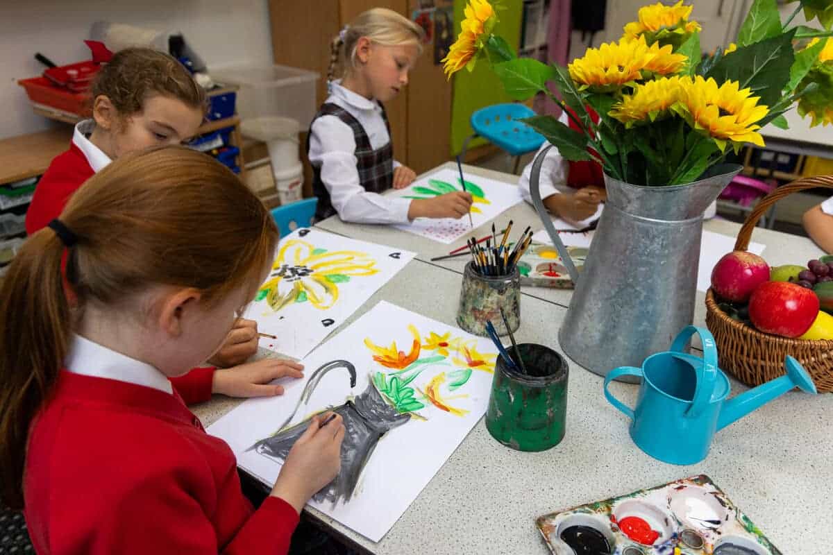 Colorful kids' watercolor painting class at World Schools art activity.