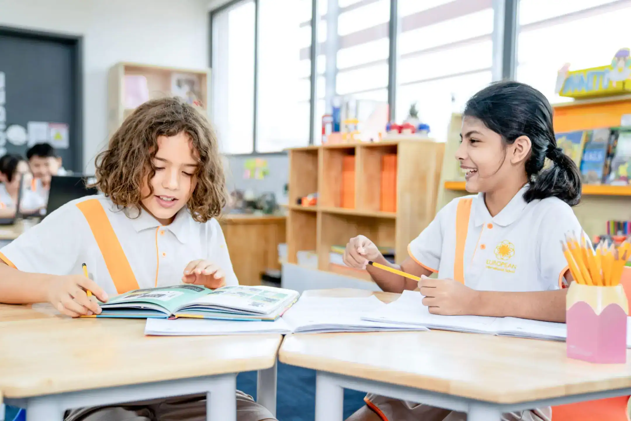 Engaging students studying together in a modern classroom at a world schools campus.