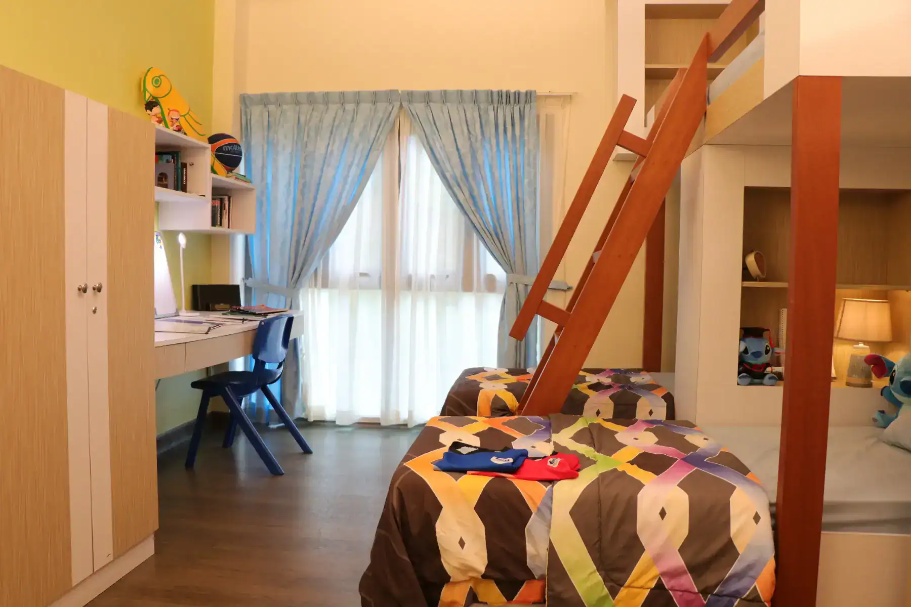 Bright modern student dorm room with bunk beds, study desk, and colorful decor, ideal for comfortable student life at World Schools.