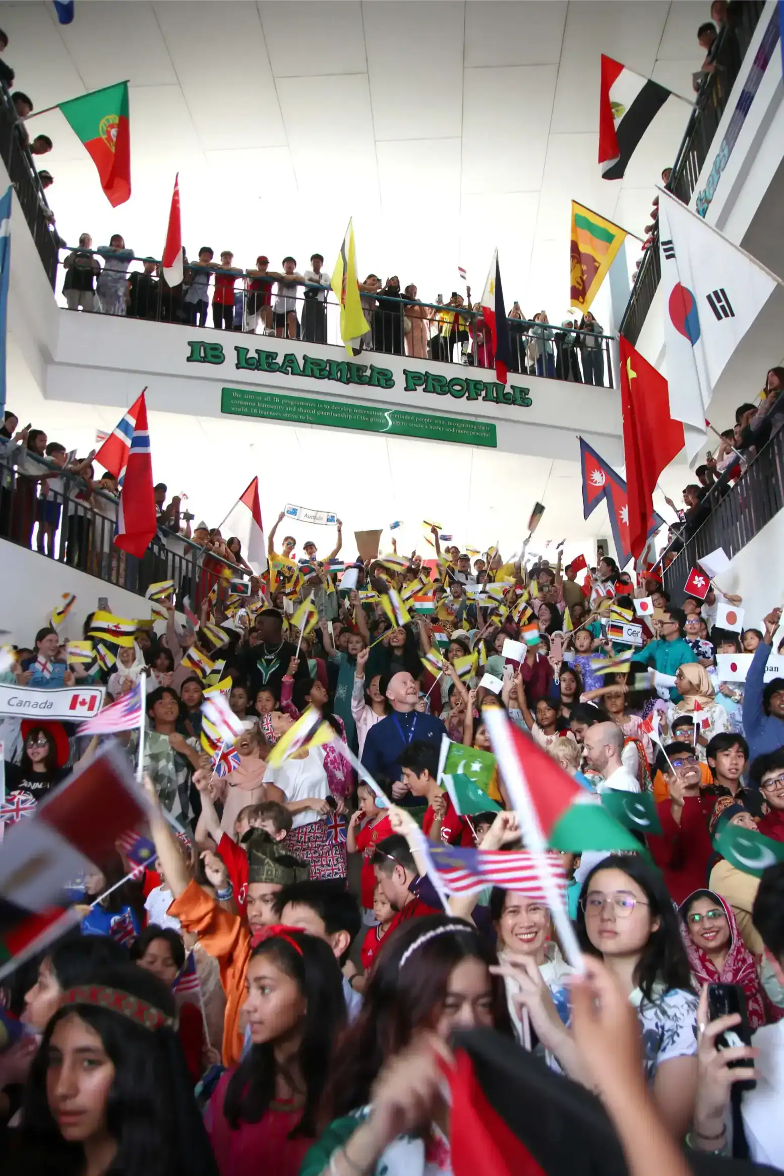 International students celebrating with flags at a world schools event for global education.