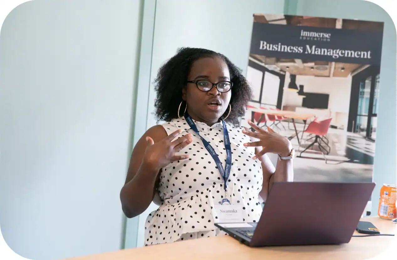 Motivated student attending Business Management seminar at World Schools conference.