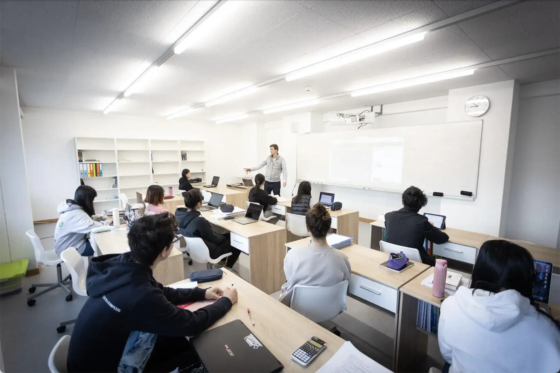Modern classroom with students studying and teacher instructing, innovative learning environment at World Schools.