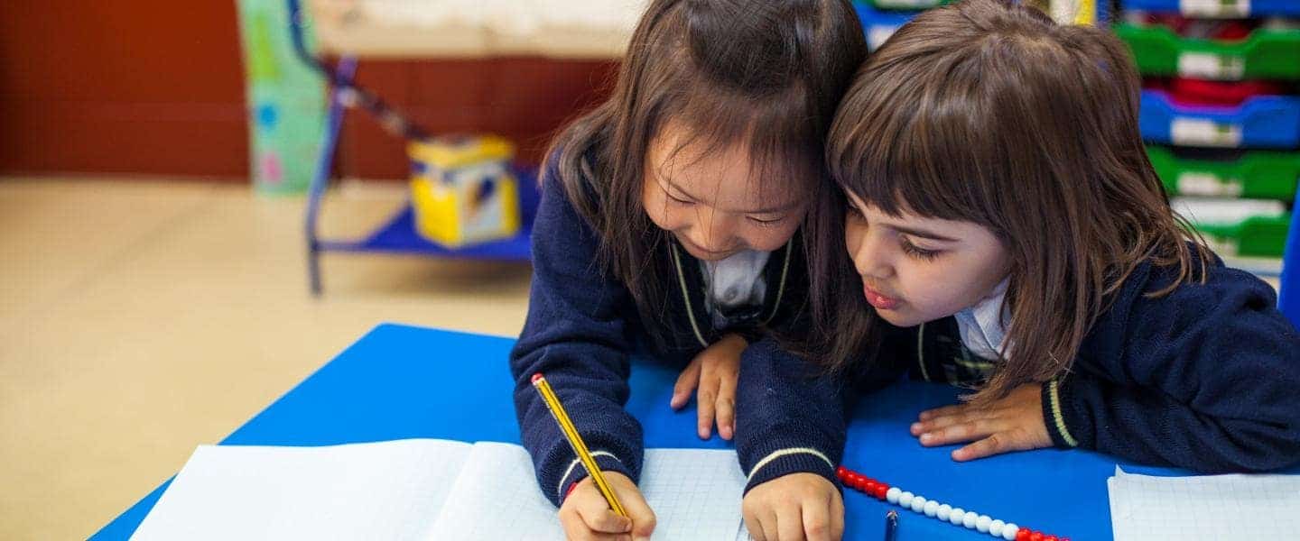 Bright young students engaged in collaborative learning at a world school, fostering global education excellence.
