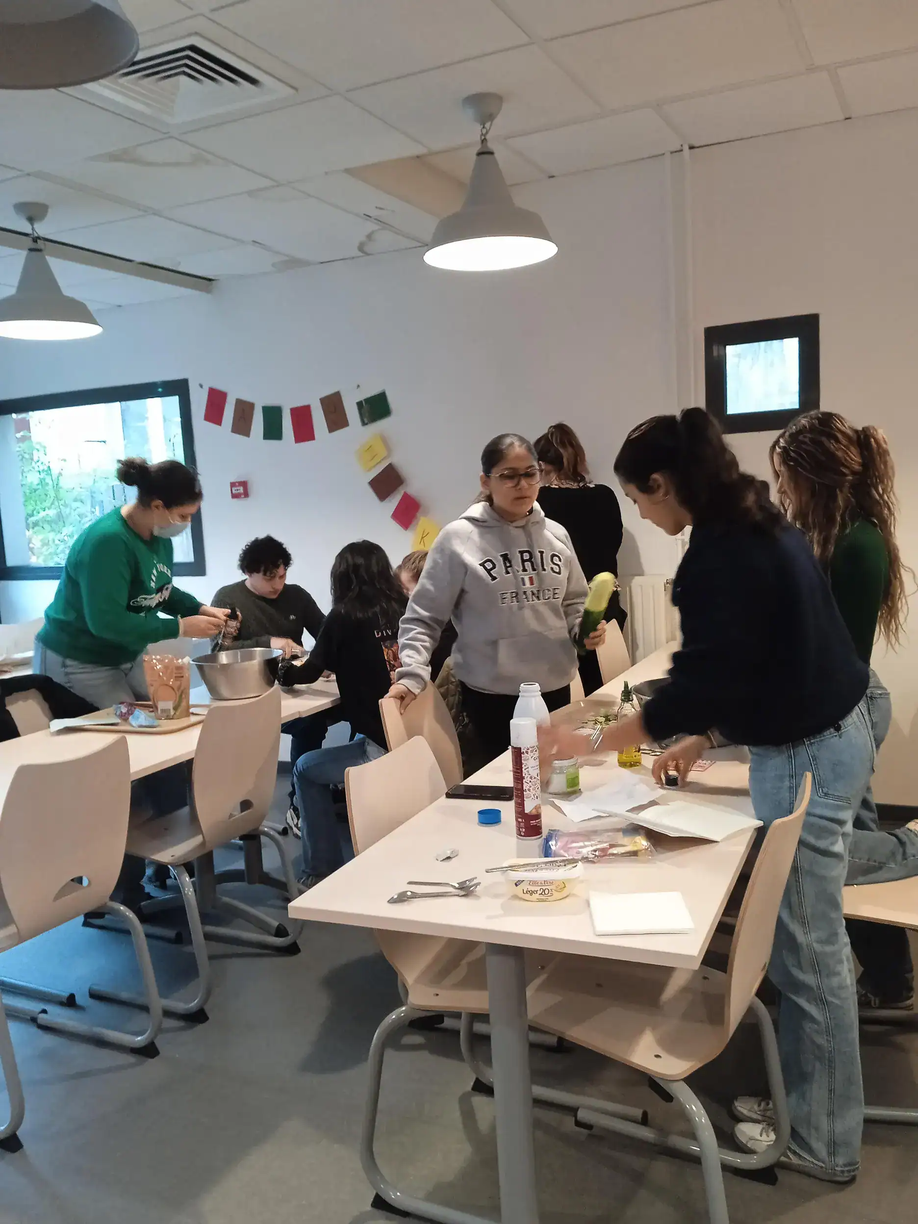 Students engaging in a cooking or science activity in a modern classroom environment.