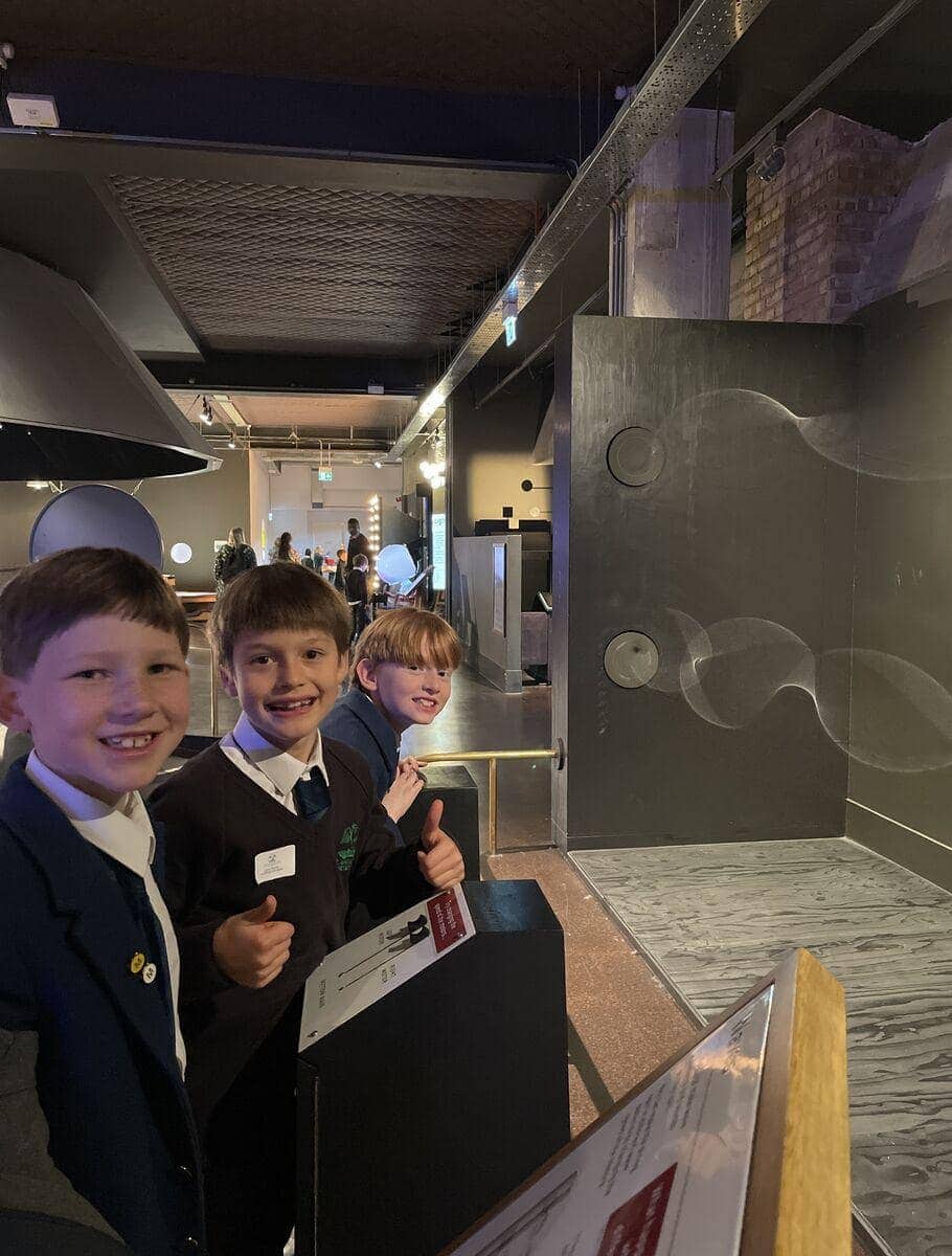 Colorful kids museum exhibit, children enjoying educational science display, interactive learning for young students.