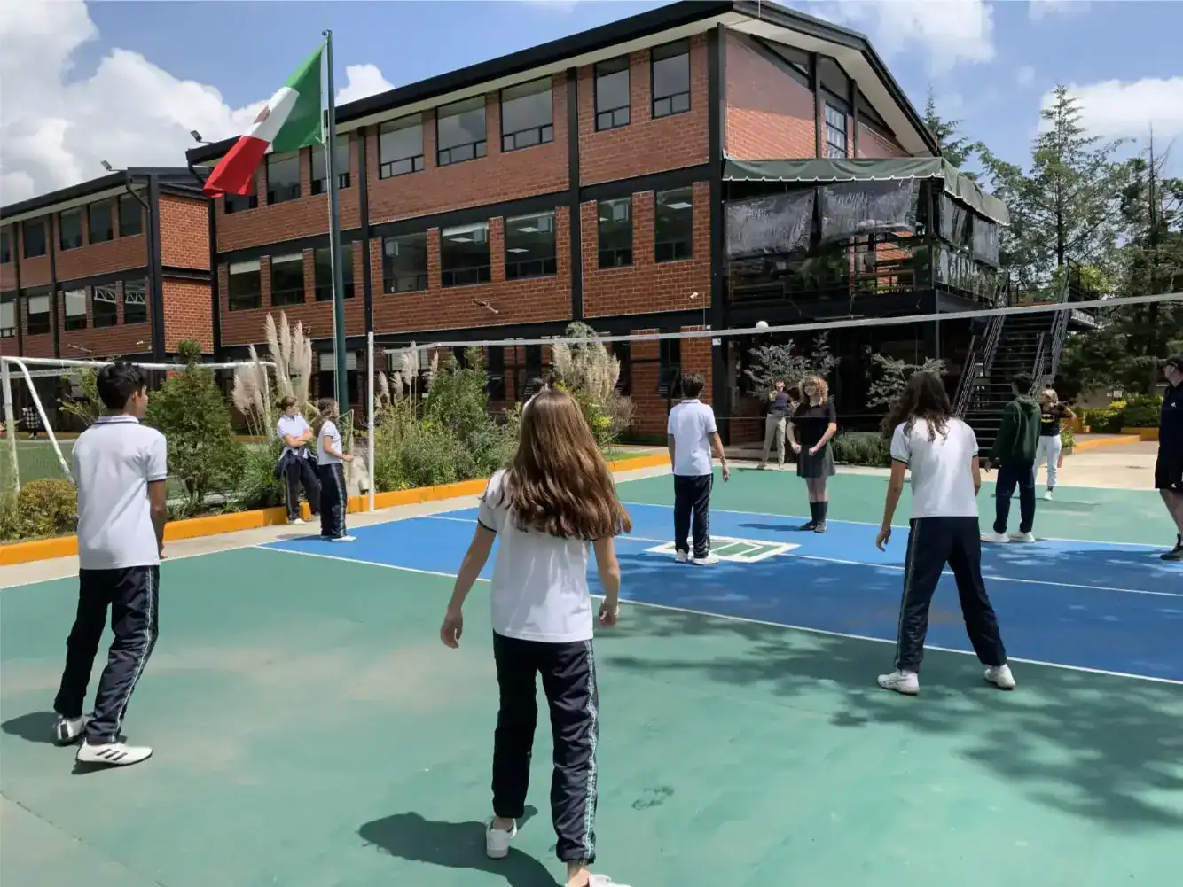 Students playing basketball on schoolyard at World Schools campus, promoting active learning and student engagement.