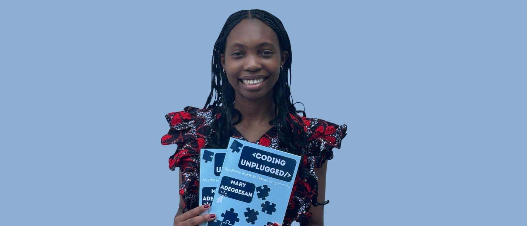 Young woman holding "Coding Unplugged" book, smiling, in online learning environment, representing digital education.