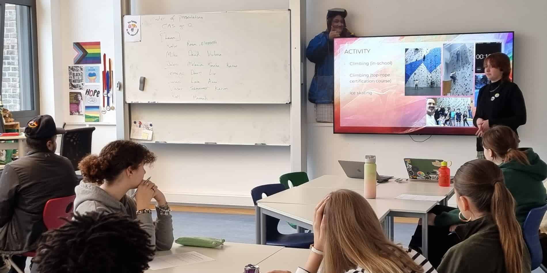 Students attending a classroom presentation at a World Schools program, focusing on extracurricular activities and global learning.