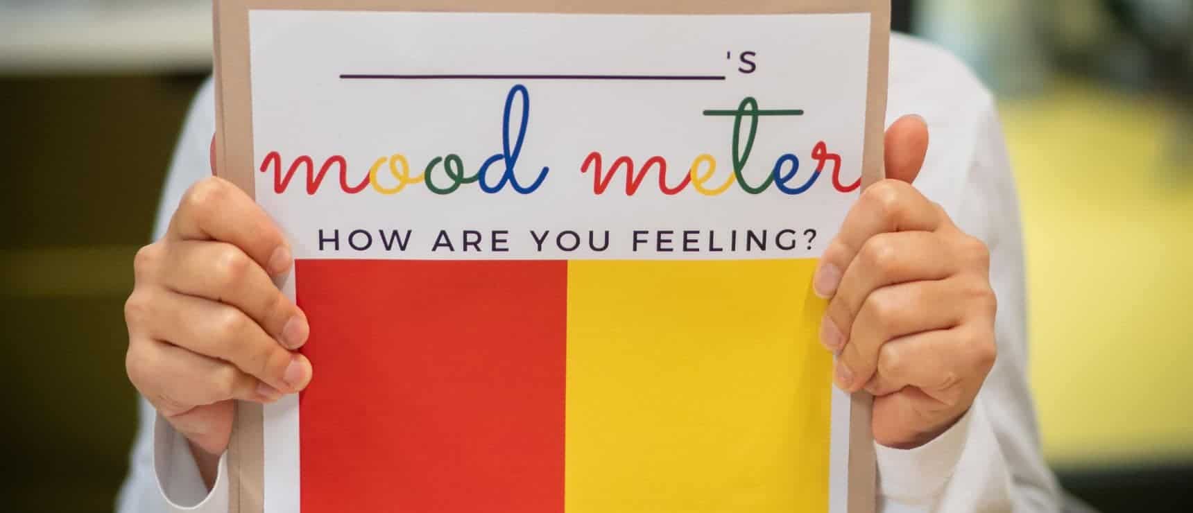 Flourishing at Ecolint: nurturing student self-esteem 4 Bright red and yellow mood meter chart at a world schools classroom for emotional well-being and student emotional learning.