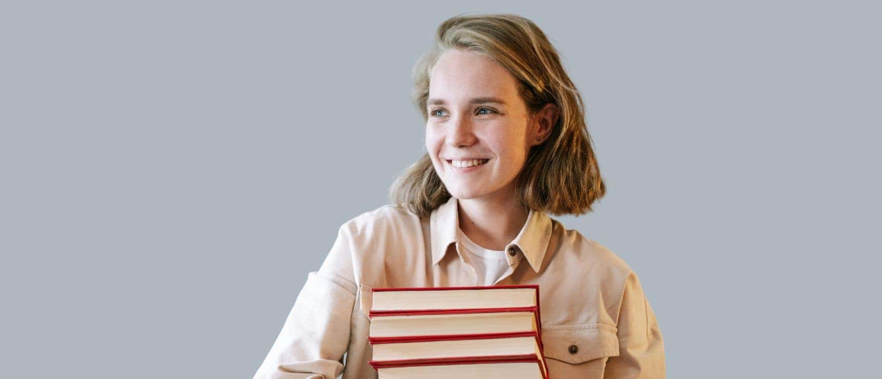 Bright female student holding books, representing world school education and academic success.
