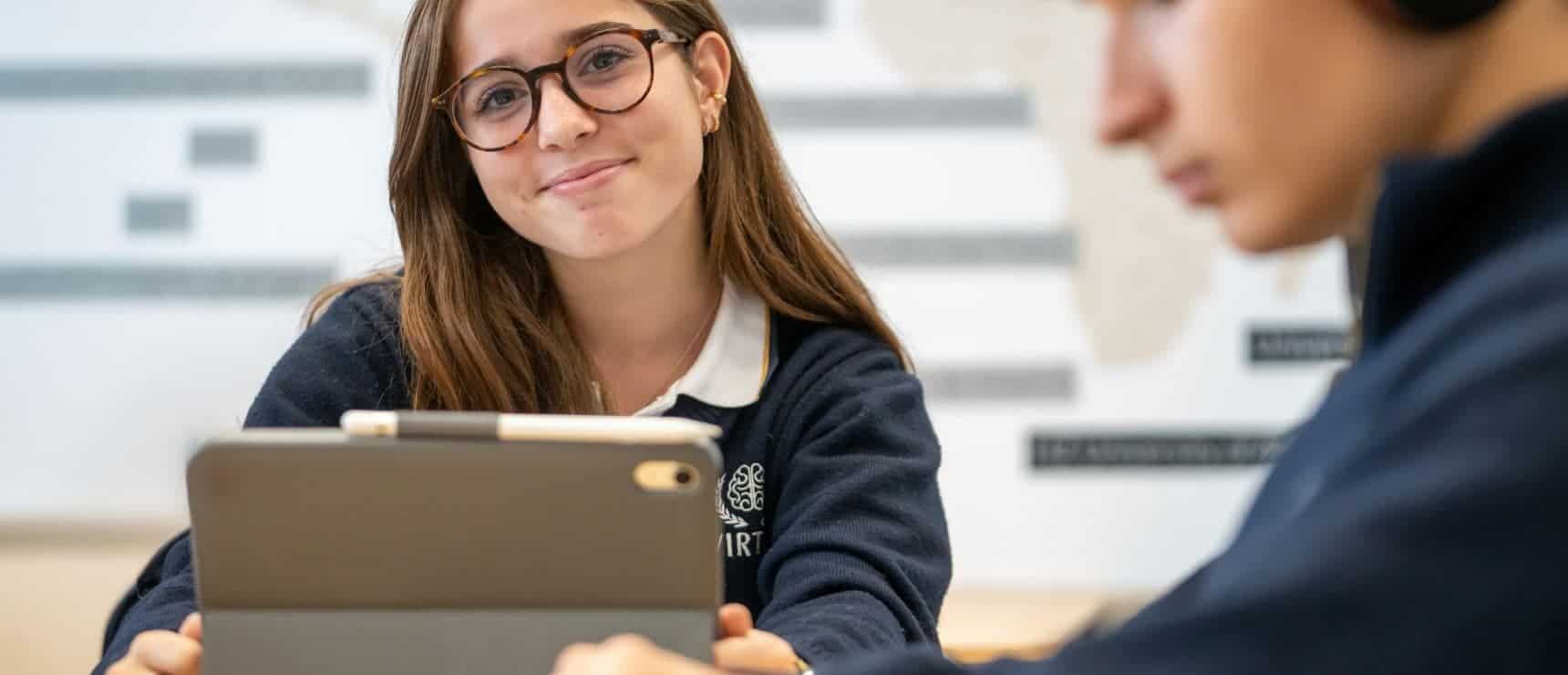 Engaged student using tablet in classroom at world school for innovative education and global learning.