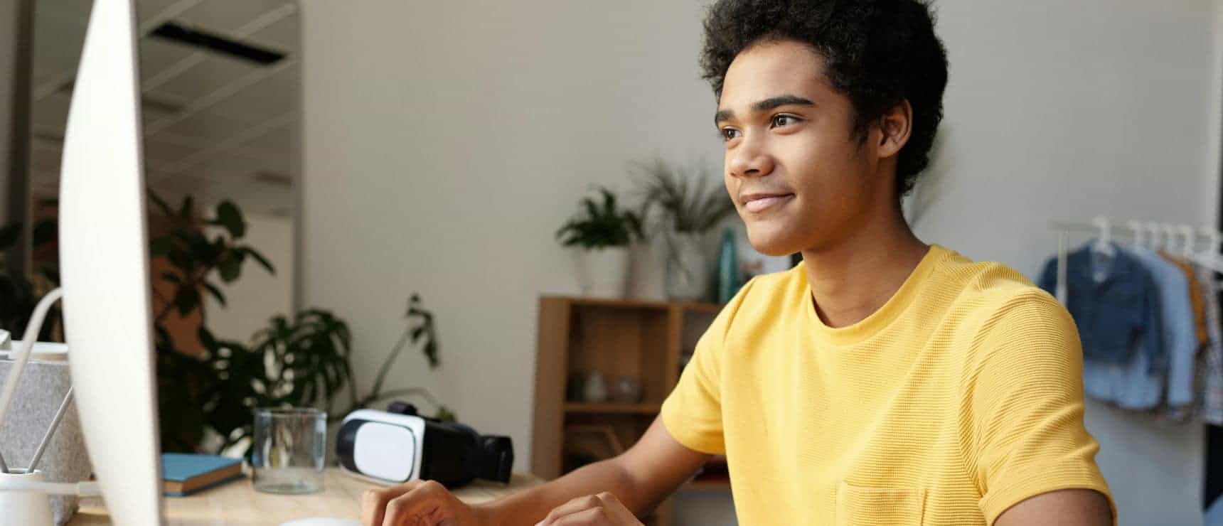 Young student studying at a computer in a modern learning environment, promoting innovative education in world schools.