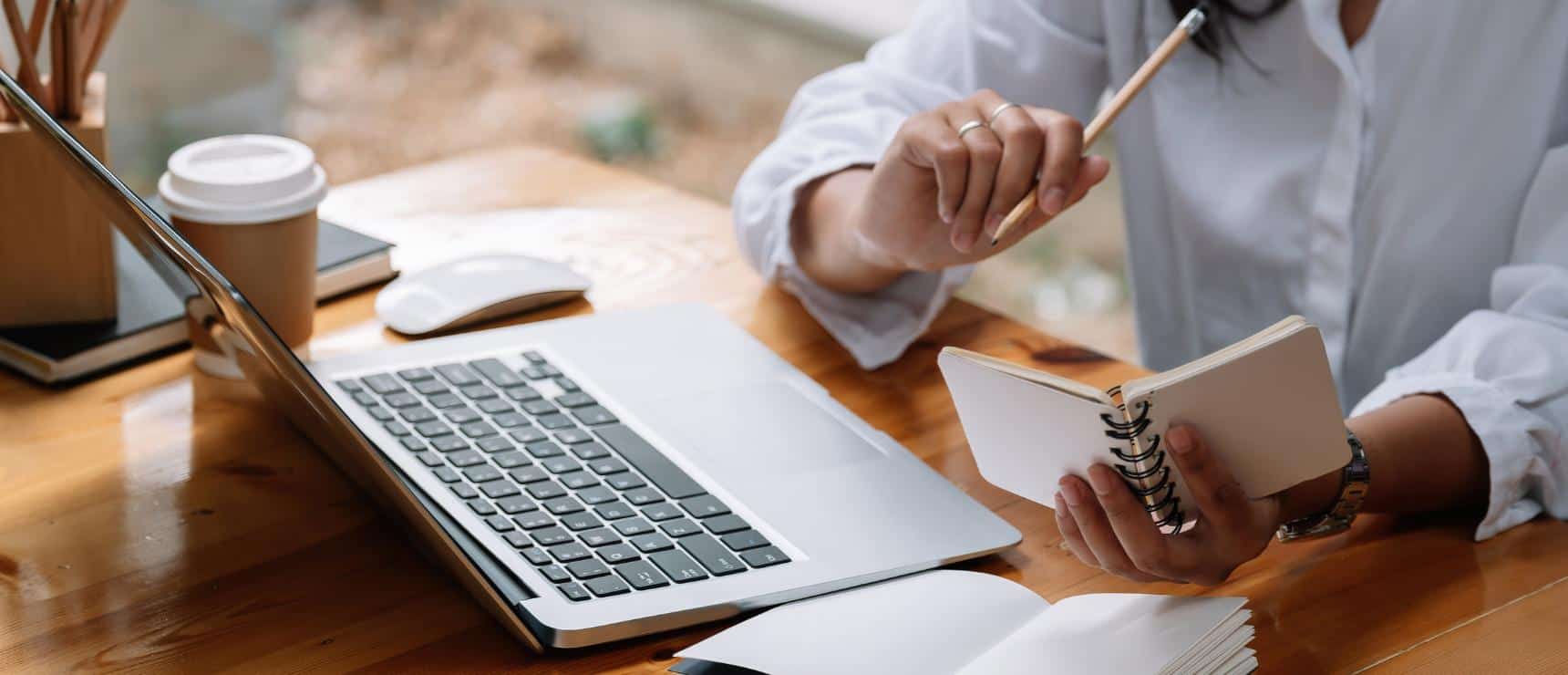Laptop and notebook for studying at a modern workspace, emphasizing online education and e-learning.