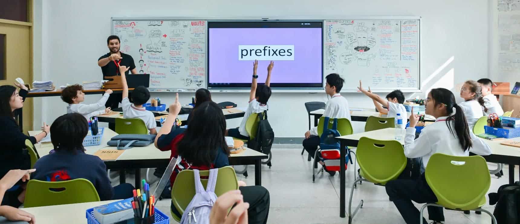 Interactive classroom in a world school with engaged students learning about prefixes.