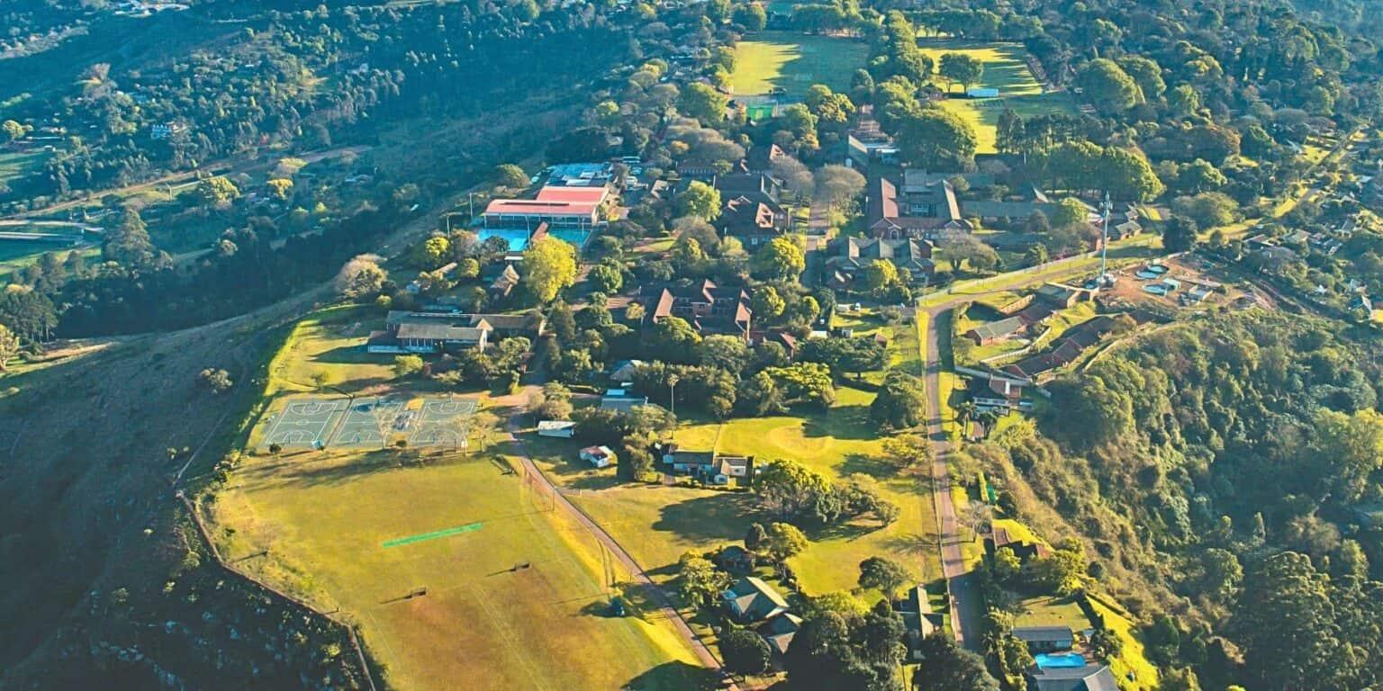 Modern school campus with sports facilities and green spaces, ideal for international students and global education programs.