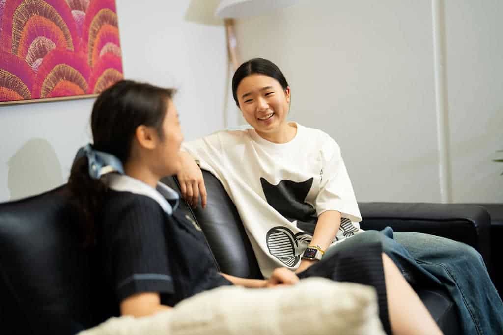 Two students having a friendly conversation in a school counseling session.