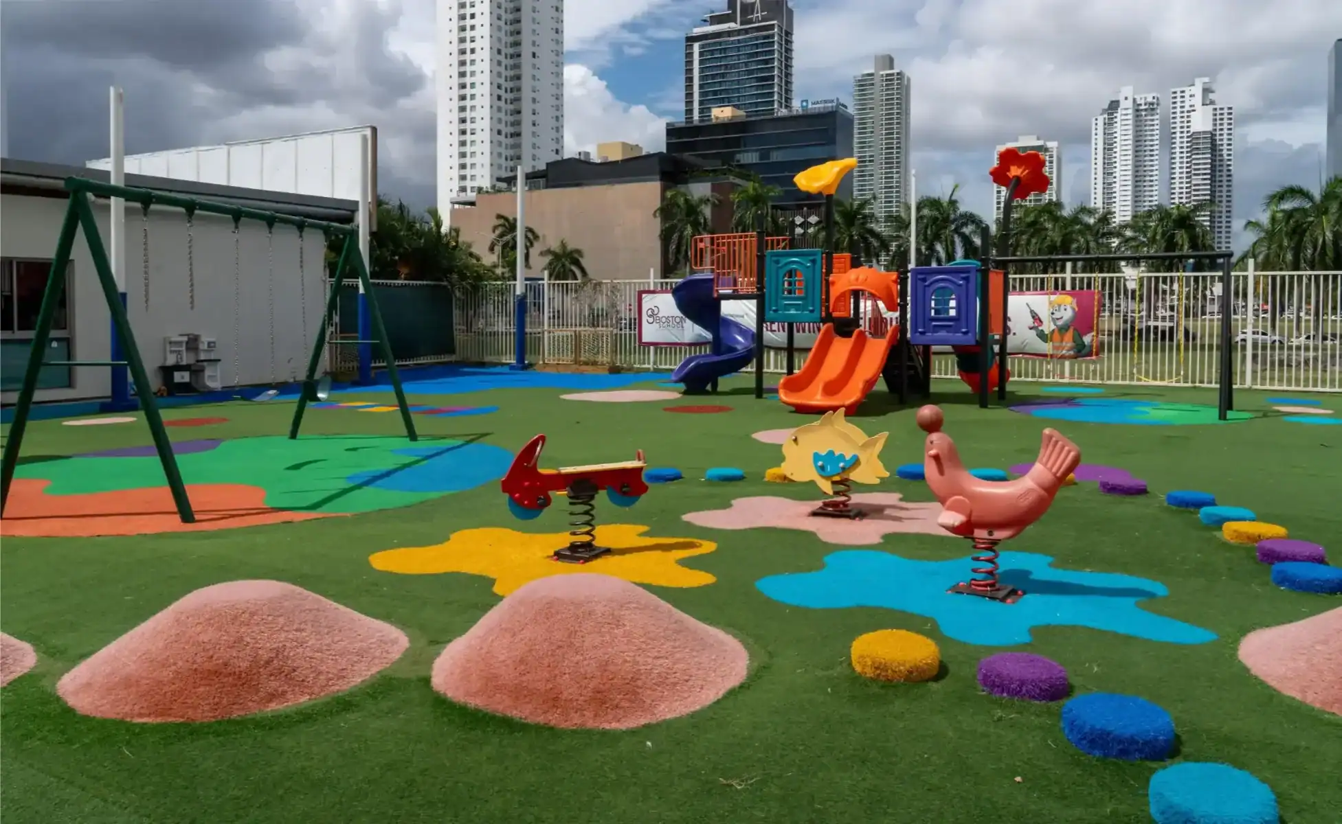 Vibrant playground area featuring slides, swings, and playful equipment at Boston School Internation.