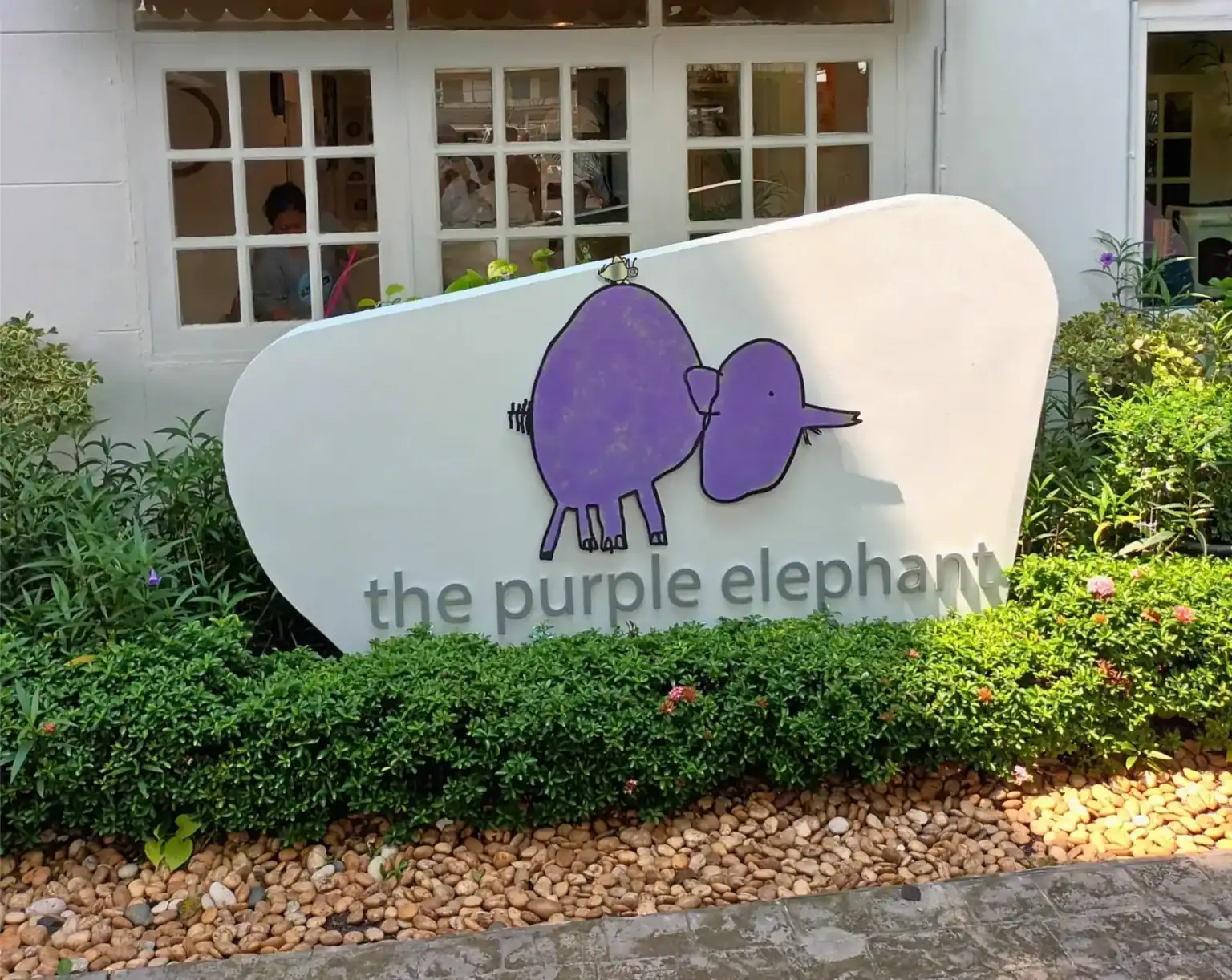 Colorful elephant logo representing The Purple Elephant international school.