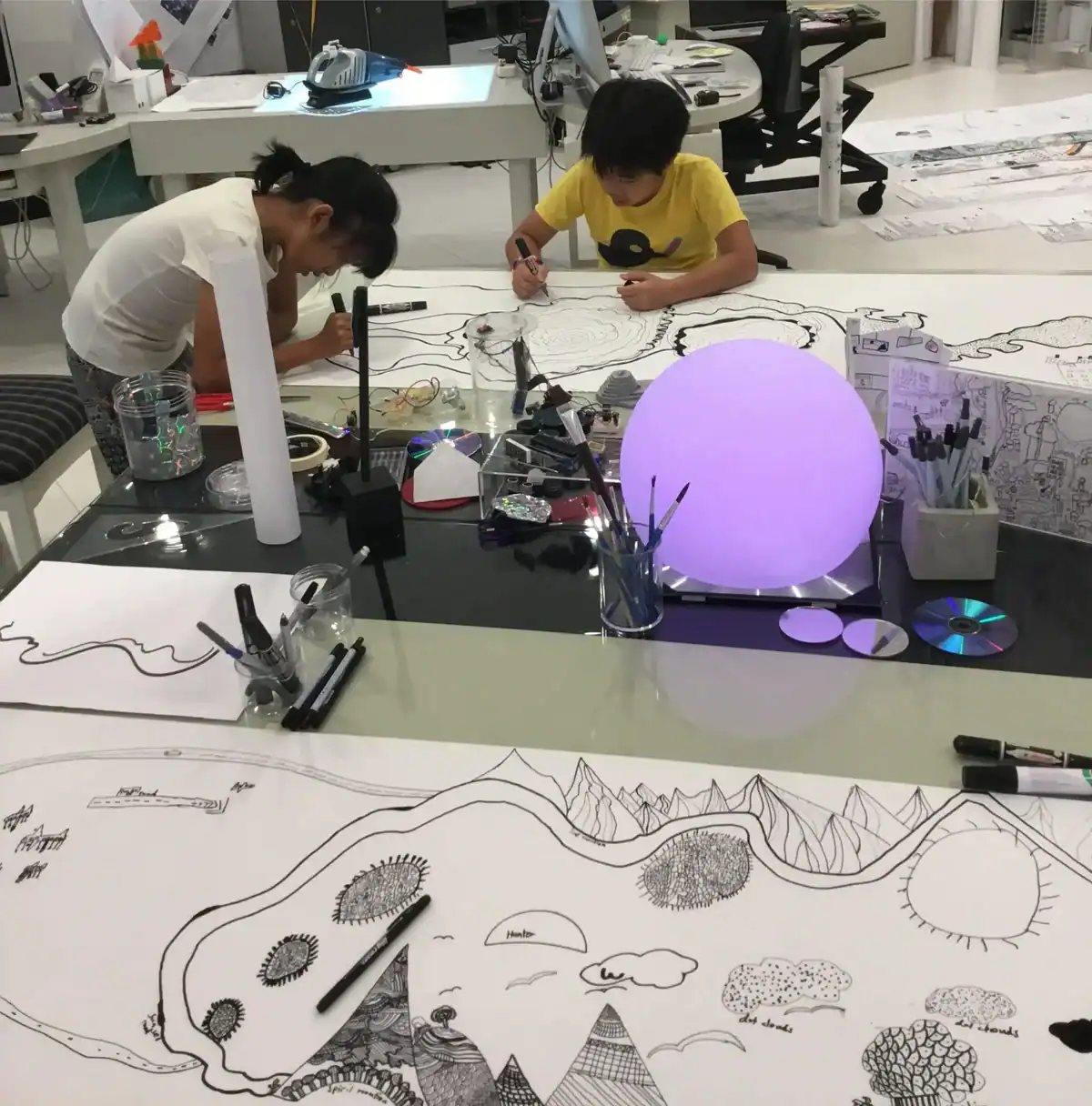 Innovative students working on creative art projects at a modern classroom with drawing and design t.