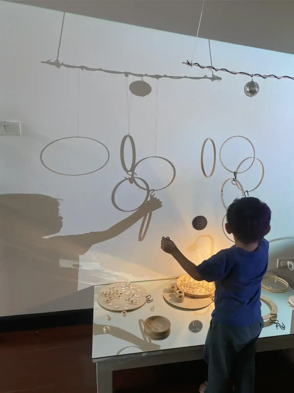 Interactive educational activity for children with hanging rings and educational toys.
