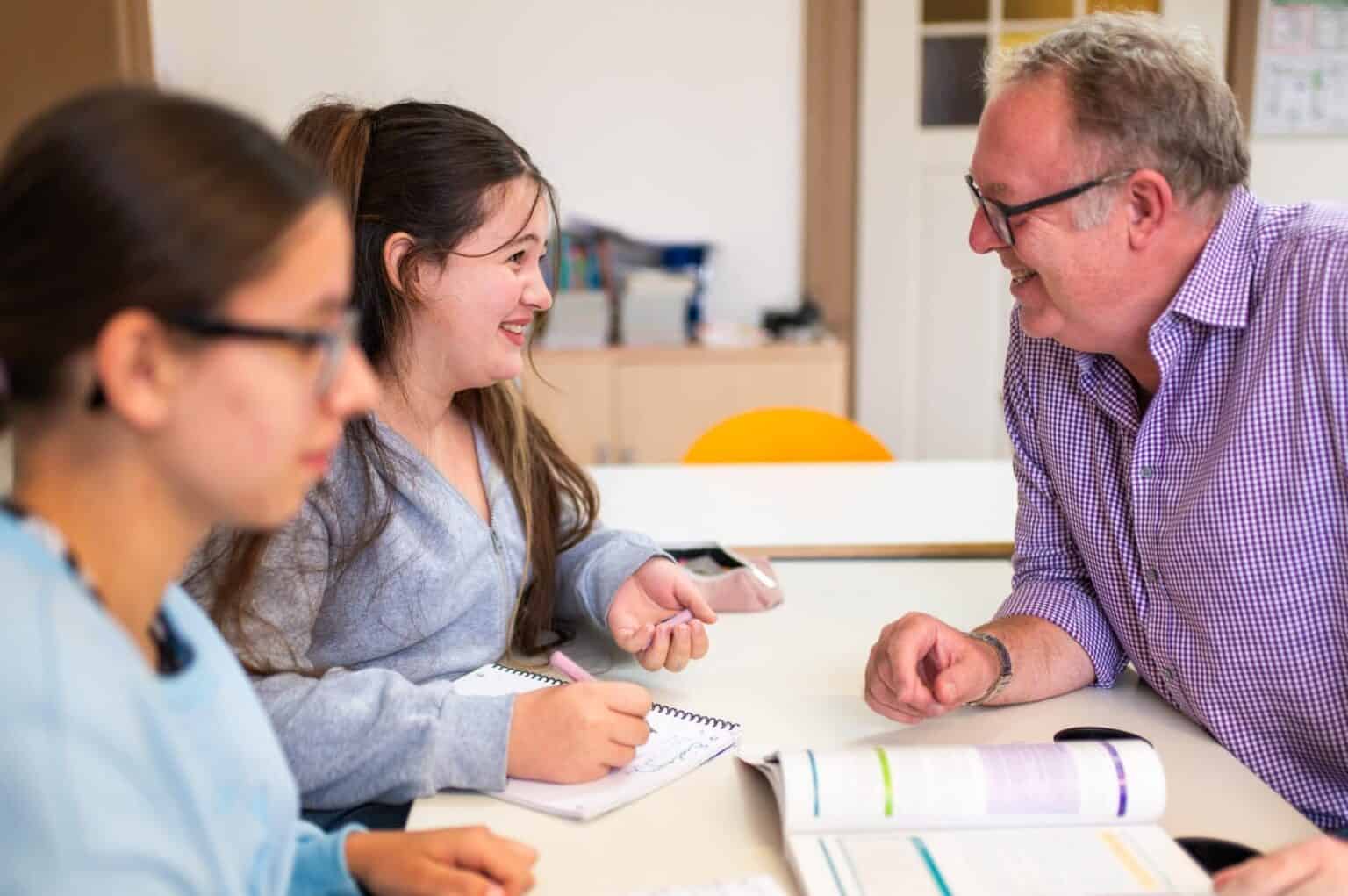 Engaging classroom scene with students and teacher promoting innovative international education.