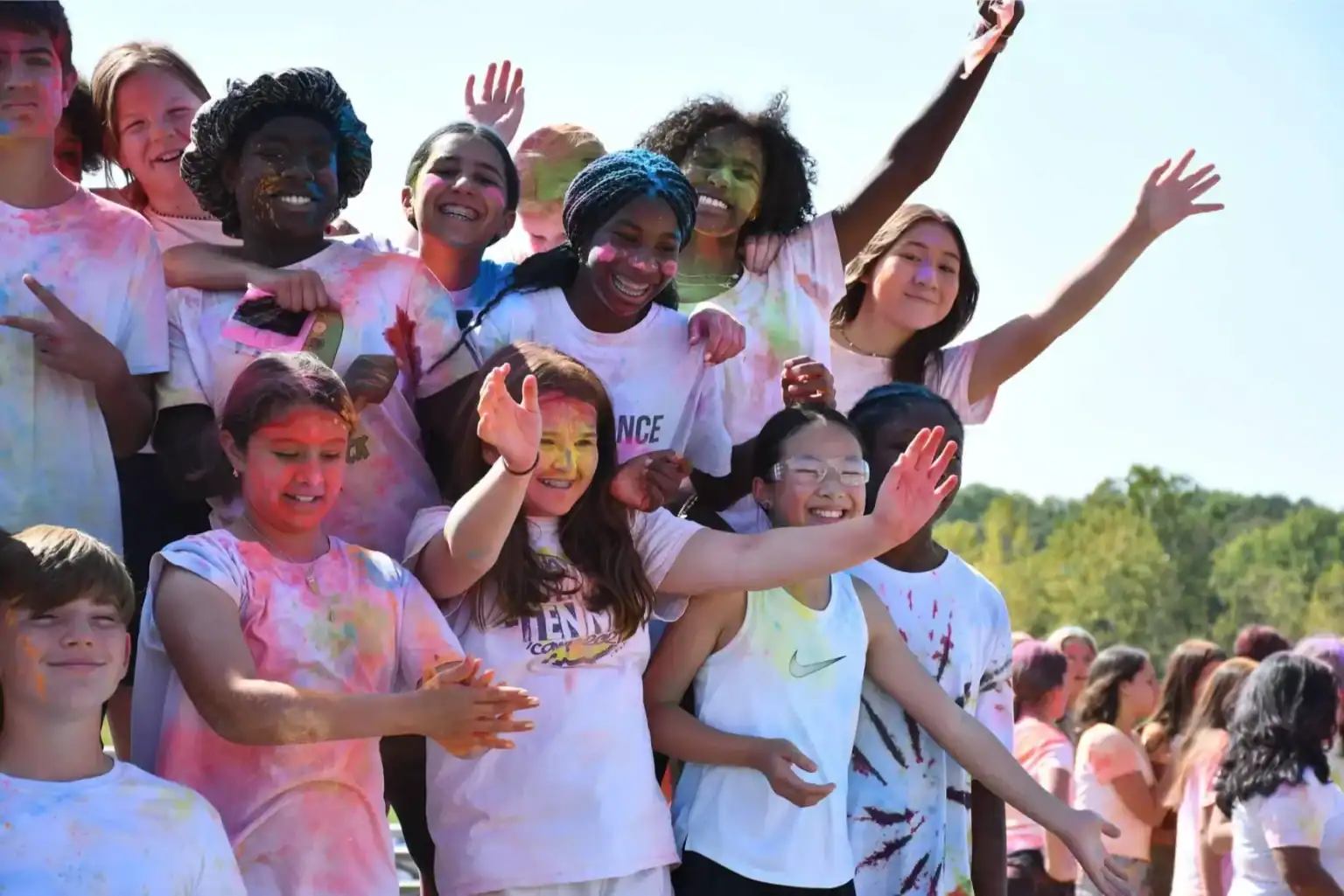 Colorful students celebrating at a school event, showcasing diversity, joy, and teamwork.