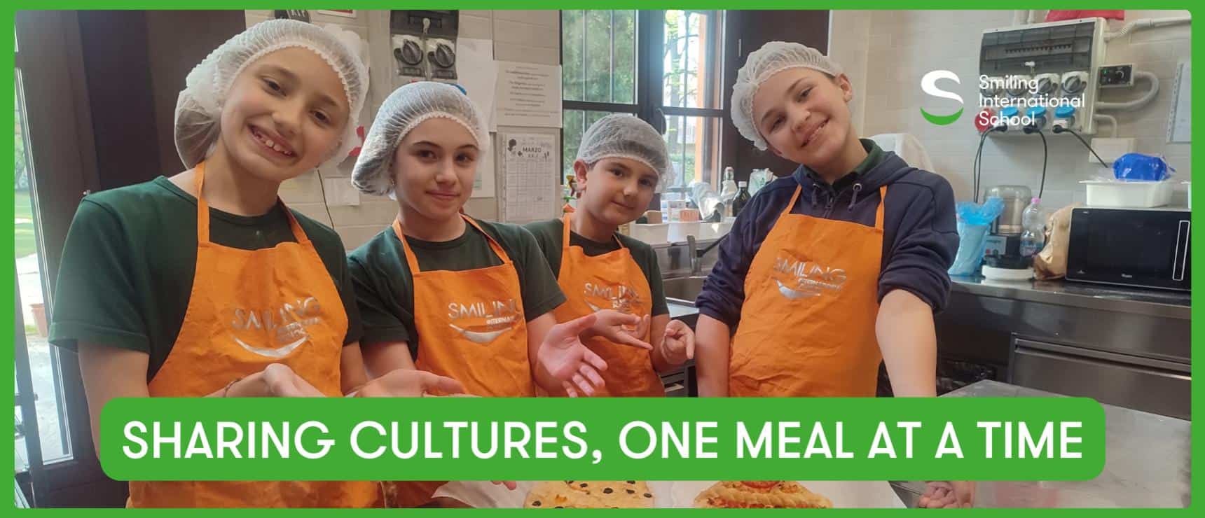 Smiling children in cooking class wearing orange aprons and hairnets at a world international school.