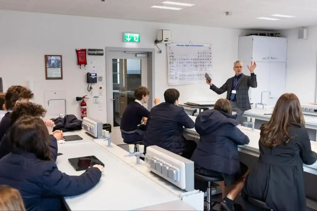 Modern classroom environment with students and teacher engaged in science lesson.