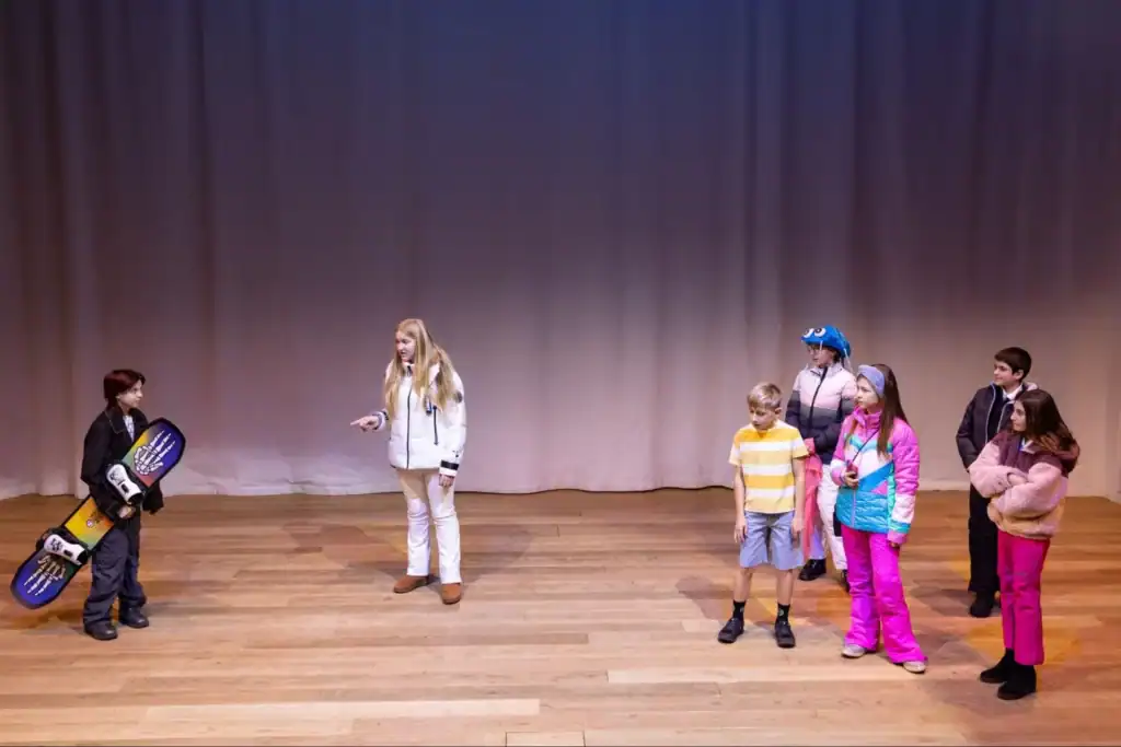 Bright students performing on stage at World Schools educational event.
