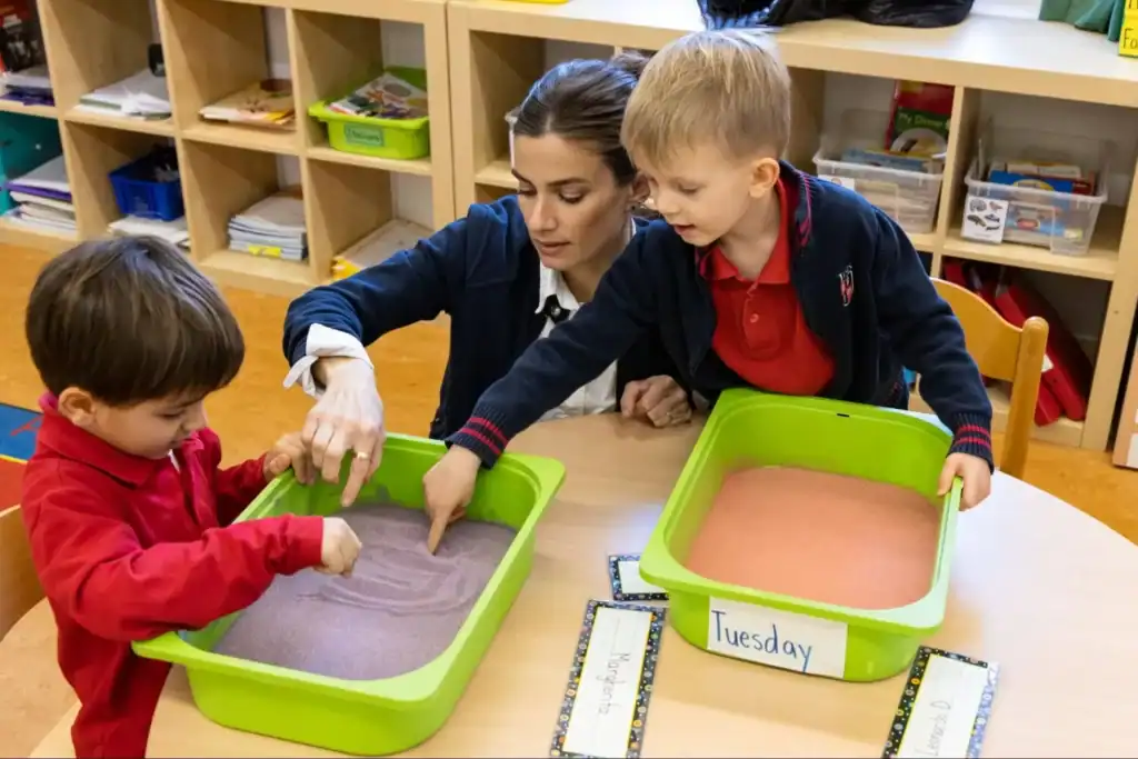 Colored sand sensory play for early childhood education at a world-class preschool.