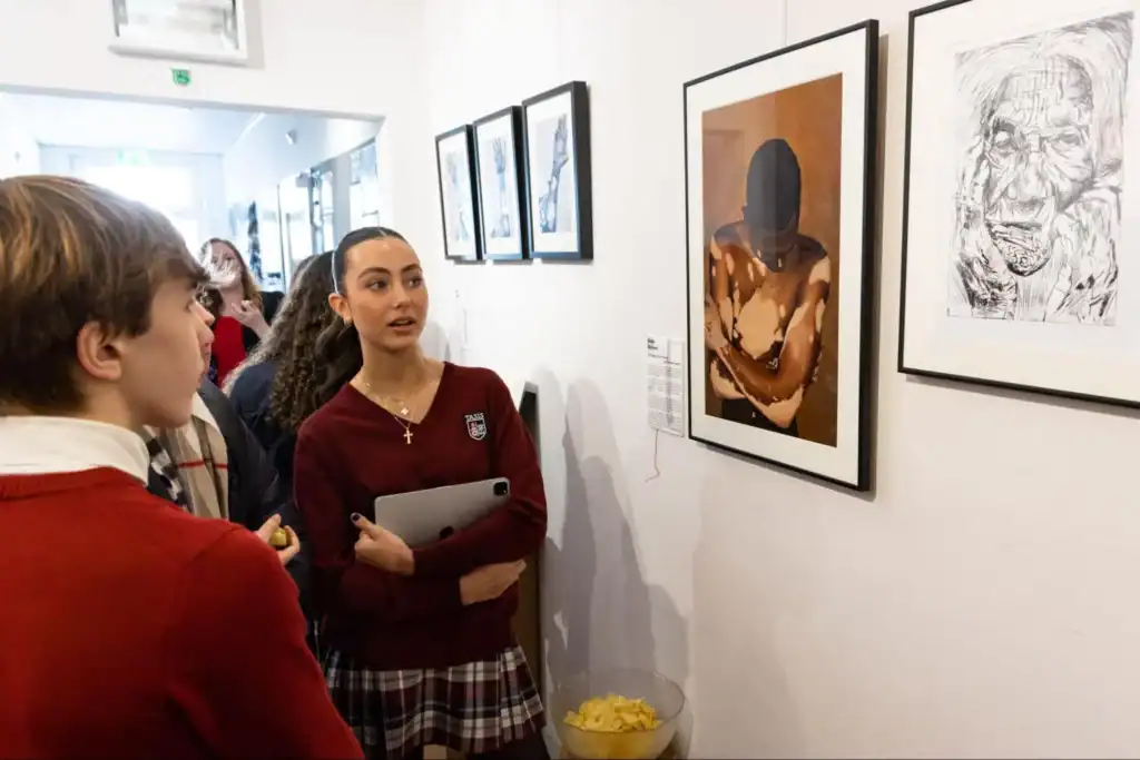 Thoughtful students viewing contemporary art at a world school exhibition.