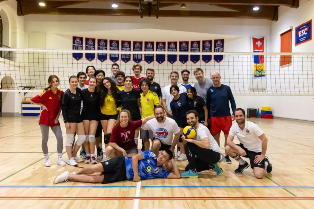 Dedicated international school volleyball team practicing at a World Schools sports event.