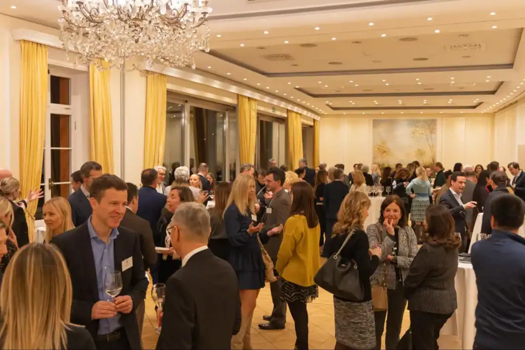 Diverse professionals networking at a formal event in an elegant banquet hall.