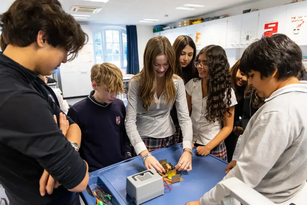 This Month at TASIS: January 2025 5 Innovative students collaborating in a classroom science experiment for a modern international school.